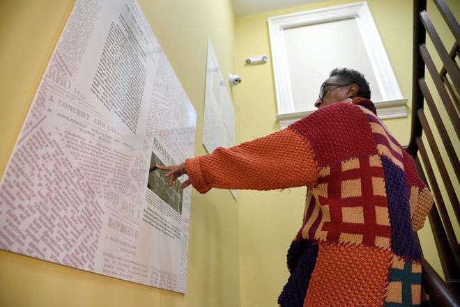 Gilda Rogers points out newspaper articles mentioning T. Thomas Fortune and his family on Saturday, Jan. 15, 2022 in Red Bank. Fortune's arrival in Red Bank was announced in the Red Bank Register, the local paper.